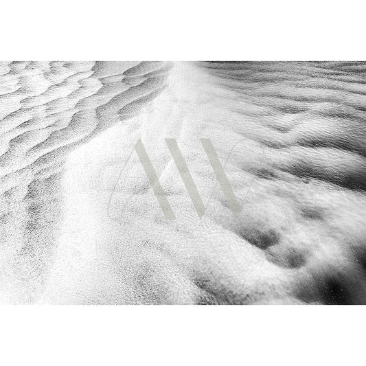 The AWP Image Librarys Noosa River Drone B&W Image 0857 resembles a drone shot of rippling sand dunes or the Noosa River waves meeting smoother areas, with textured patterns that evoke movement and striking contrast to captivate the viewers eye.