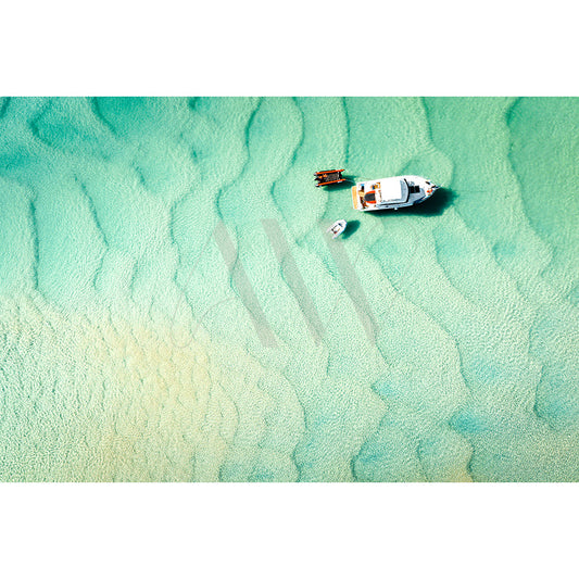 The AWP Image Library offers the Noosa River Drone Image 0283, capturing a white boat by a small dock in clear, turquoise water with visible sand textures. A smaller boat is tethered nearby, all amidst tranquil surroundings.